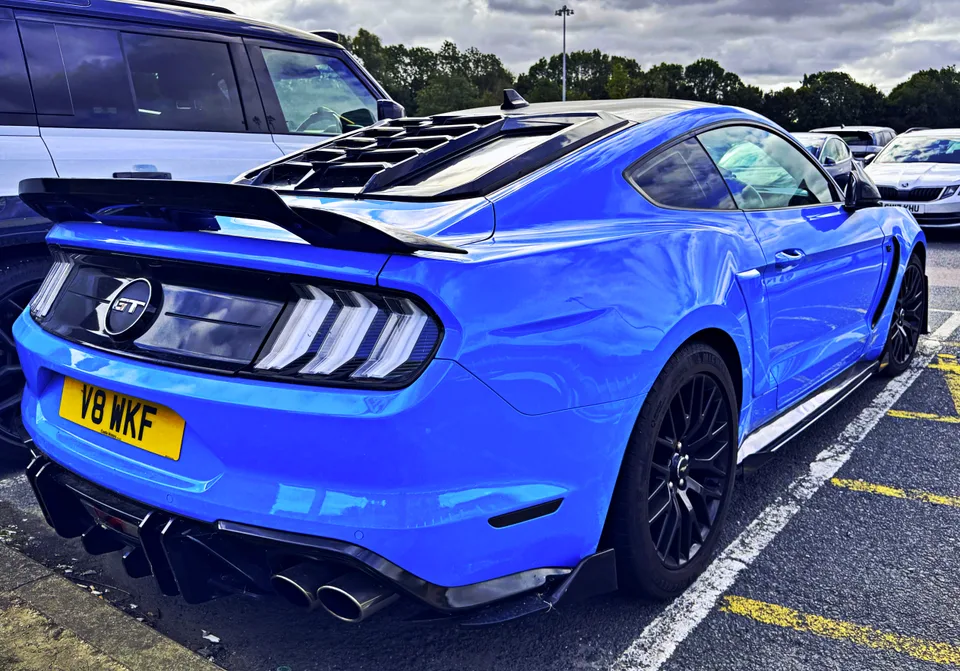 Blue Ford Mustang, rear three-quarter view