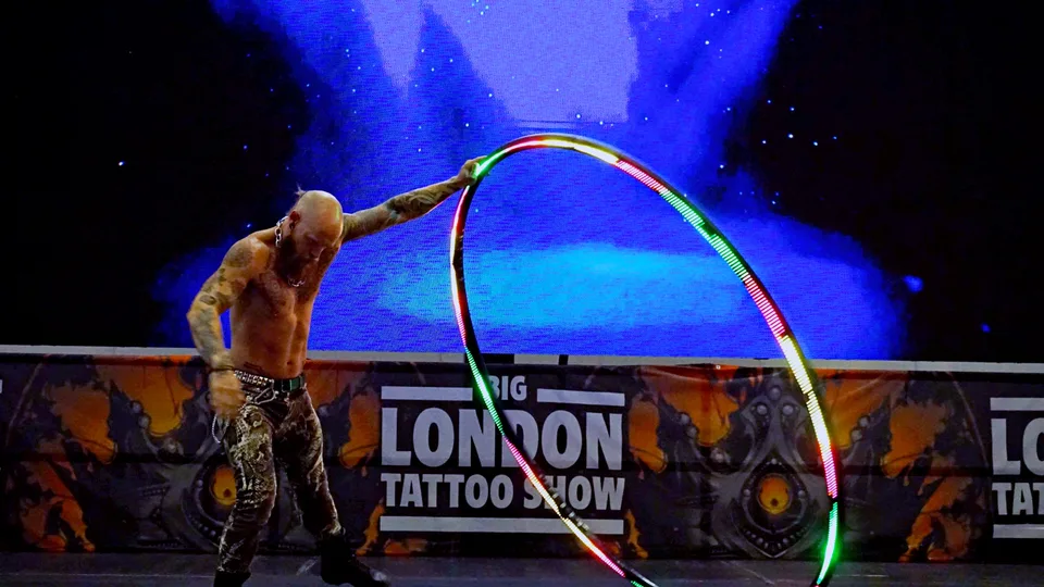 Performer leaning into a spinning hoop