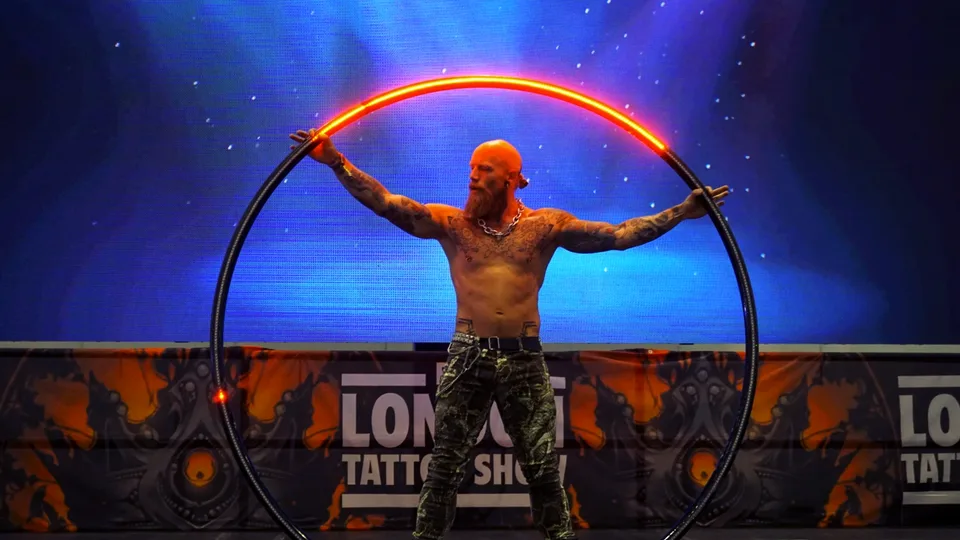 Performer holding a hoop with arms outstretched