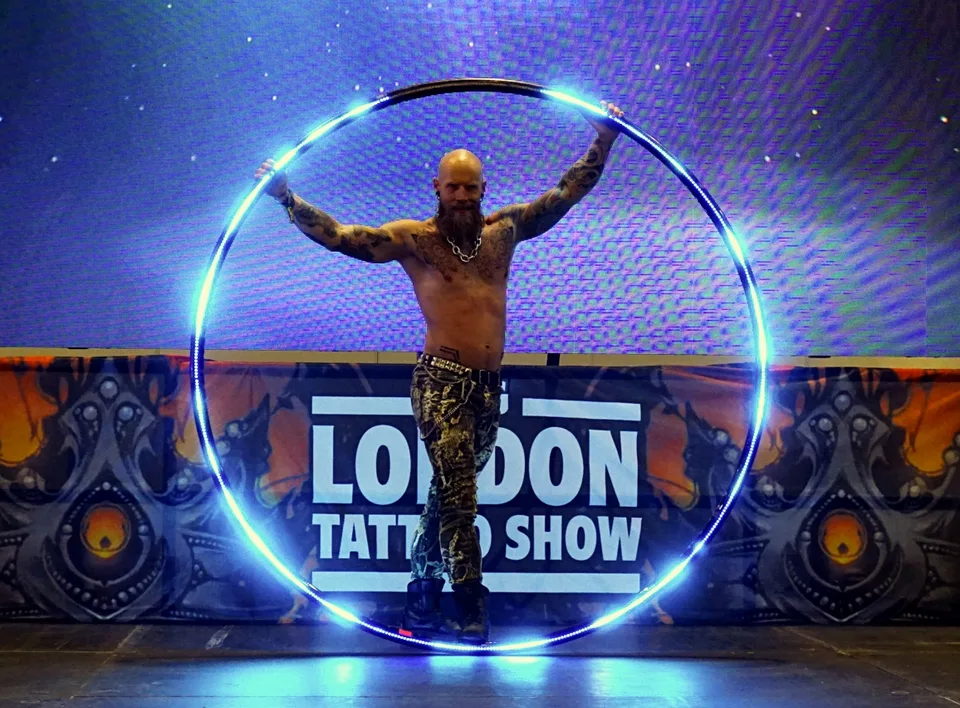 Performer stepping through a glowing hoop