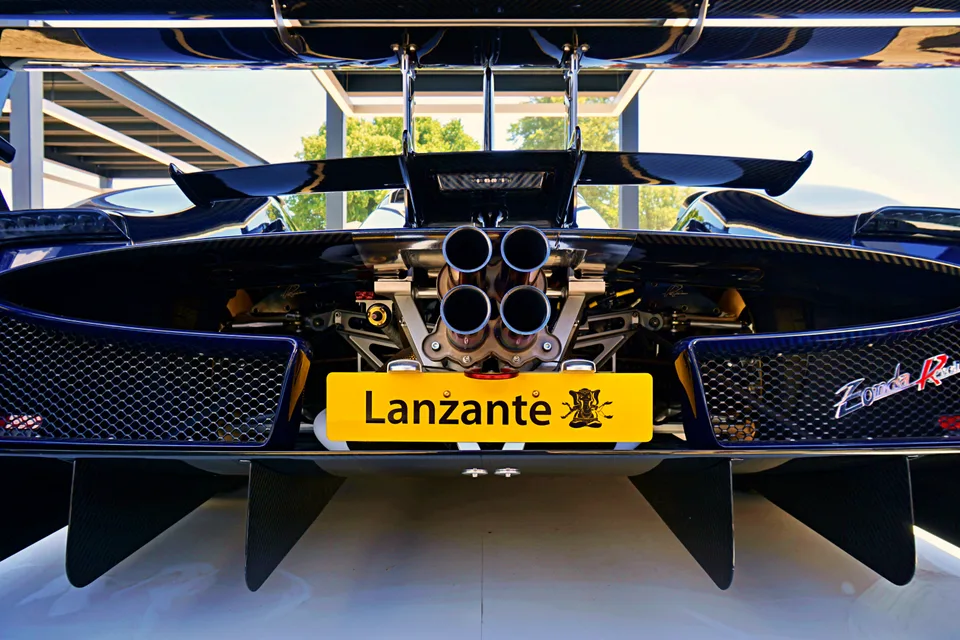 Sports car rear wing and central exhausts