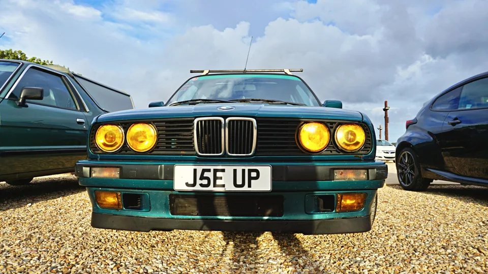 Green BMW with yellow headlights