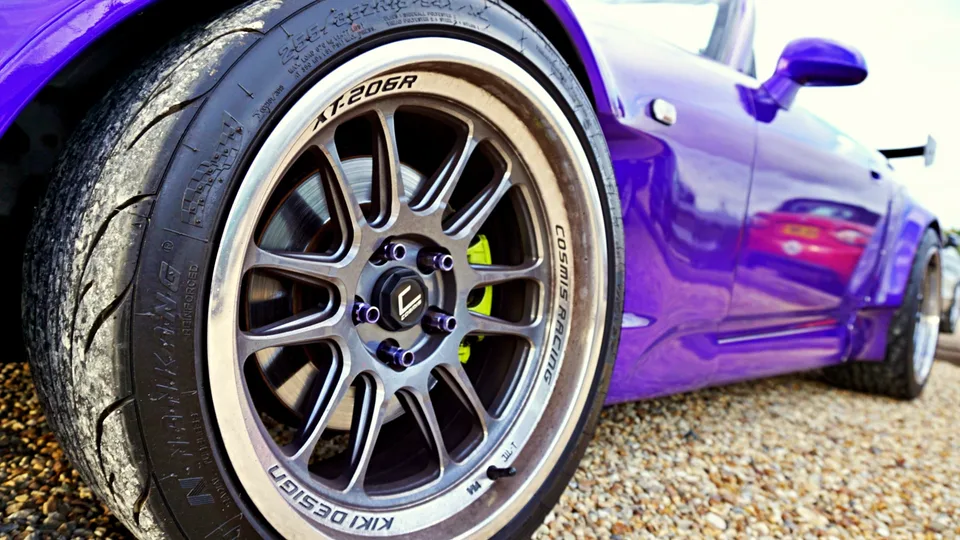 Purple sports car wheel and bodywork detail